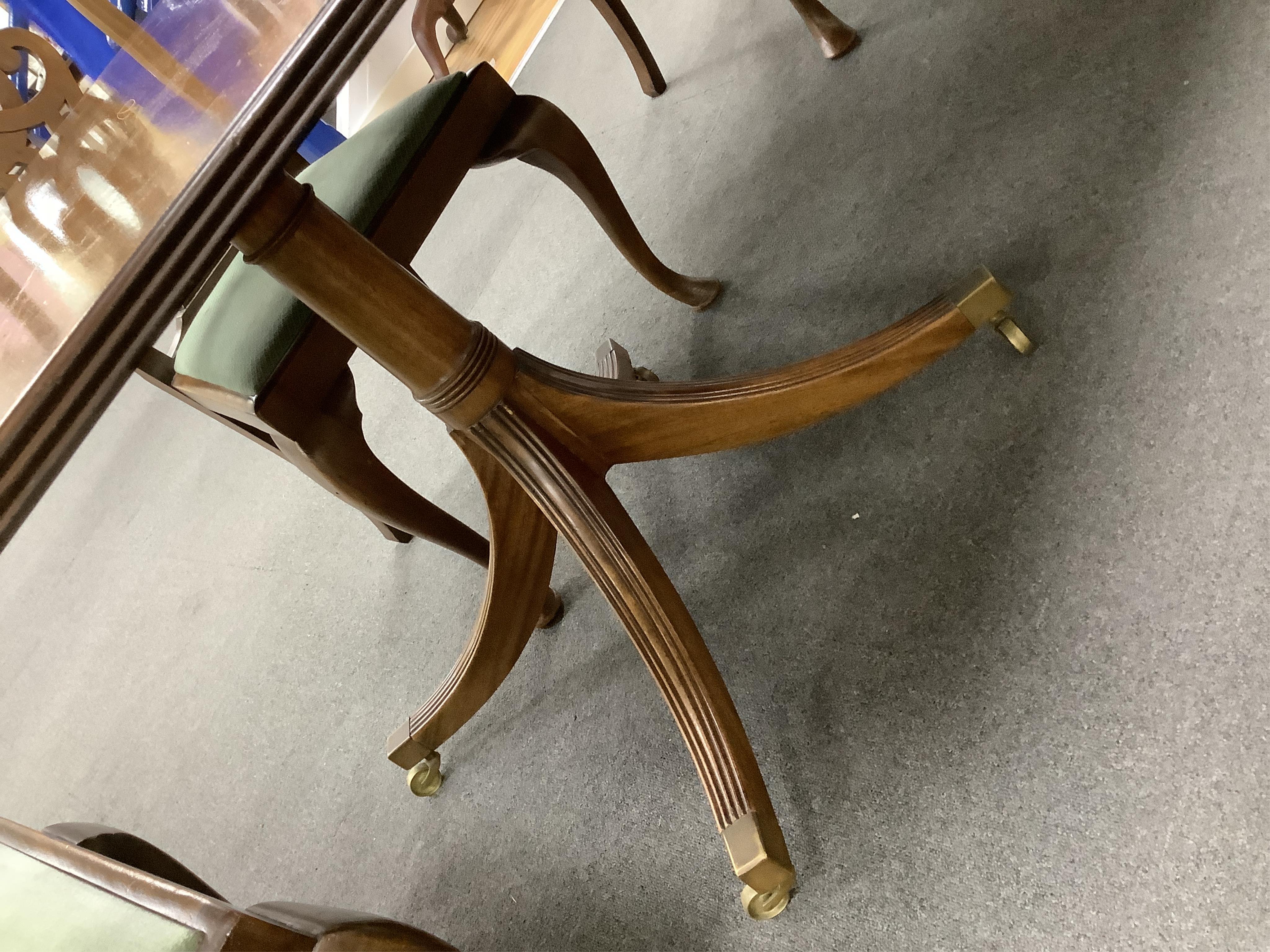 A Regency style mahogany twin pillar extending dining table, width 295cm extended, two spare leaves, depth 114cm, height 74cm